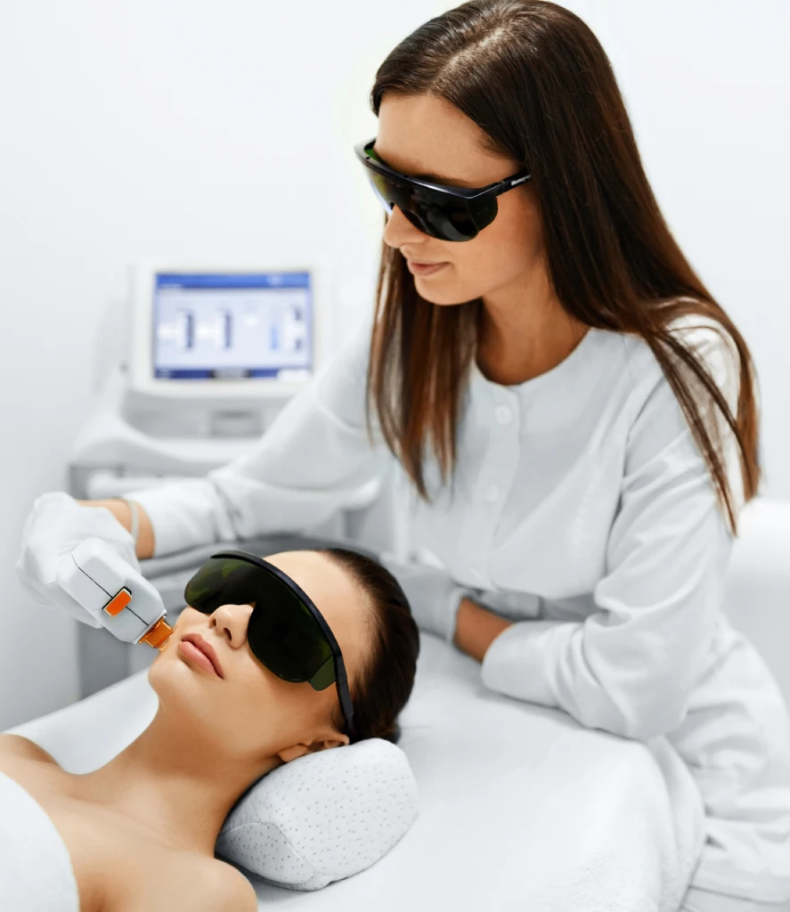 Close-up of a clinician performing IPL PhotoFacial Treatment on a woman's face with a handheld device at Refine Med Spa in Centennial, CO, targeting sun damage, redness, and uneven skin tone for a clearer complexion.