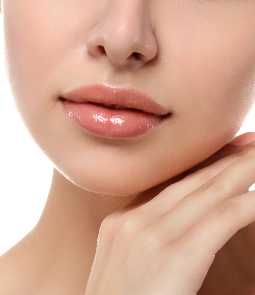 Close-up of a medical professional performing venous lake removal on a patient’s lower lip using a handheld laser tool. The treatment takes place at Refine Med Spa in Centennial, Colorado, with a focus on the dark vascular lesion being targeted.
