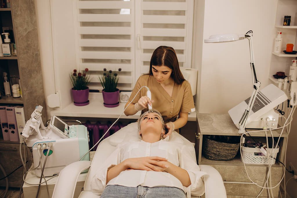 Esthetician performing facial treatment on client