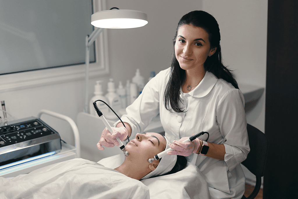 Esthetician performing professional facial device treatment