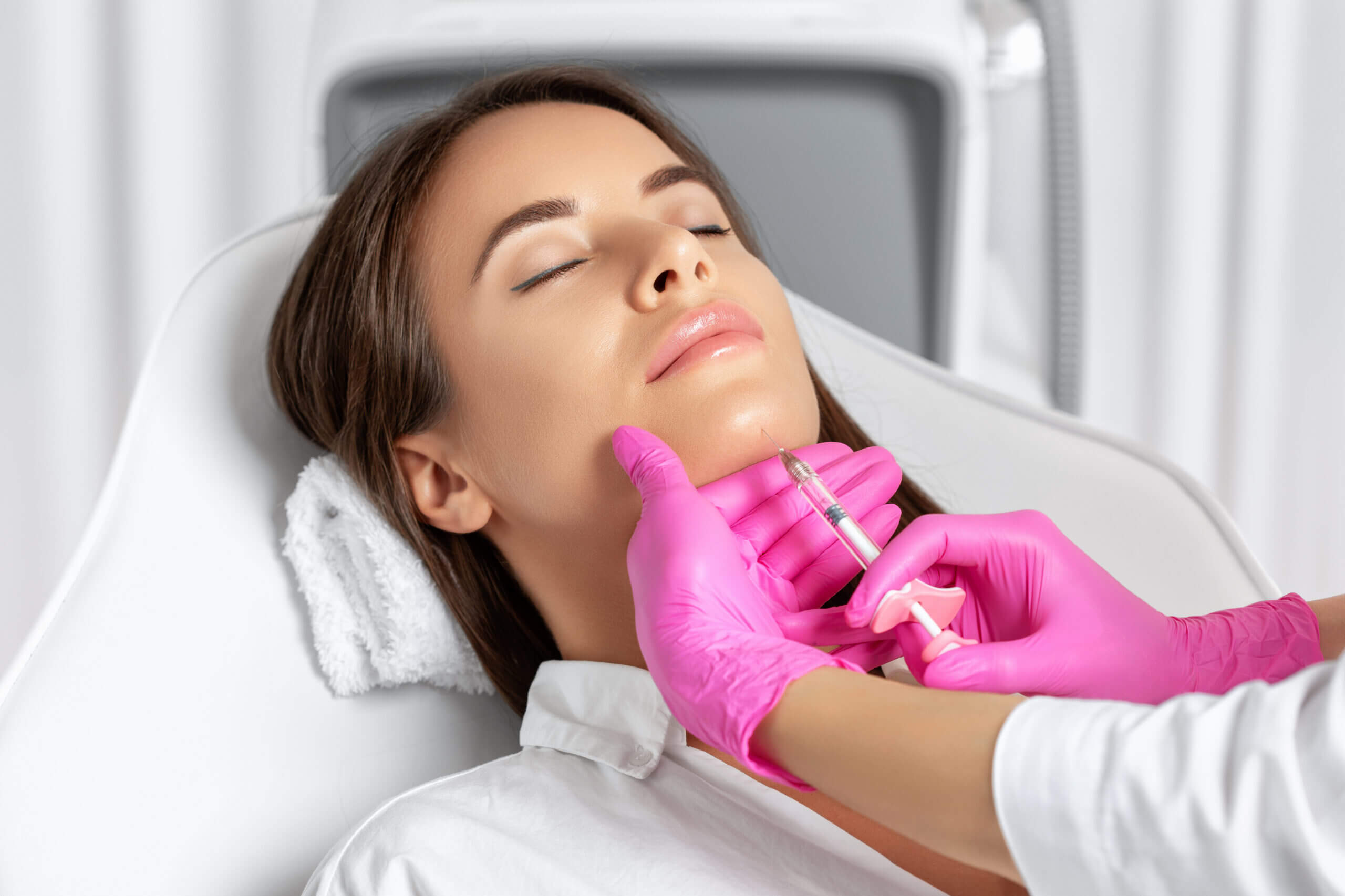 Woman receiving cosmetic chin injection